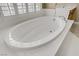 Large soaking tub with white surround, and natural light at 8125 Turbys Treehouse Pl, Las Vegas, NV 89131