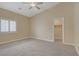 This primary bedroom boasts neutral walls, carpet floors, a ceiling fan and a closet at 8125 Turbys Treehouse Pl, Las Vegas, NV 89131