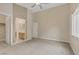 The primary bedroom features carpet floors, white trim, and an ensuite bathroom with double doors at 8125 Turbys Treehouse Pl, Las Vegas, NV 89131