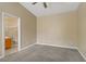 Comfortable bedroom with ceiling fan and view into the bathroom at 8125 Turbys Treehouse Pl, Las Vegas, NV 89131