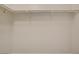 The walk-in closet has white walls and two metal racks to hold clothes, shoes, or accessories at 8125 Turbys Treehouse Pl, Las Vegas, NV 89131