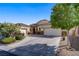 Lovely exterior elevation of a home with a three car garage, well maintained landscaping and a circular driveway at 8125 Turbys Treehouse Pl, Las Vegas, NV 89131