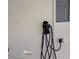 This garage features a convenient Tesla charging station for electric vehicle owners at 8125 Turbys Treehouse Pl, Las Vegas, NV 89131