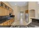Bright kitchen features wood cabinets, stainless steel appliances, and black granite countertops at 8125 Turbys Treehouse Pl, Las Vegas, NV 89131