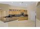 Bright kitchen features wood cabinets, stainless steel appliances, and black granite countertops at 8125 Turbys Treehouse Pl, Las Vegas, NV 89131