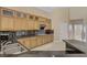 Kitchen featuring granite countertops, tile backsplash, lots of wood cabinets, stainless steel appliances, and tile flooring at 8125 Turbys Treehouse Pl, Las Vegas, NV 89131