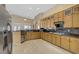 Well-lit kitchen showcasing stainless steel appliances, granite countertops, and tiled floors at 8125 Turbys Treehouse Pl, Las Vegas, NV 89131
