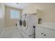 Laundry room with front loading washer, dryer, and utility sink at 8125 Turbys Treehouse Pl, Las Vegas, NV 89131
