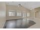 Bright living room area with tile and wood flooring, high ceilings, neutral colors, ceiling fan, and plantation shutters at 8125 Turbys Treehouse Pl, Las Vegas, NV 89131
