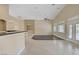 Bright and open living room area with wood and tile floors, breakfast bar, ceiling fan, and plantation shutters at 8125 Turbys Treehouse Pl, Las Vegas, NV 89131