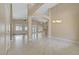 Bright and open living room offers high ceilings, neutral colors, and tiled floors throughout the space at 8125 Turbys Treehouse Pl, Las Vegas, NV 89131