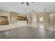 Spacious living room with tile and wood flooring, an open layout, and stylish built-in cabinets at 8125 Turbys Treehouse Pl, Las Vegas, NV 89131