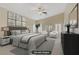 Spacious main bedroom featuring neutral colors, large windows with plantation shutters, and a ceiling fan at 8125 Turbys Treehouse Pl, Las Vegas, NV 89131