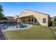 This backyard features a sparkling pool, pergola, and turf, creating the perfect outdoor retreat at 8125 Turbys Treehouse Pl, Las Vegas, NV 89131
