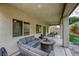 Backyard with a covered patio featuring comfortable seating and a fire pit, artificial turf, and a dining area at 8137 Crushed Velvet Pl, Las Vegas, NV 89166