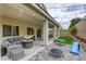Backyard featuring a covered patio, string lights, comfortable seating, and a small play area at 8137 Crushed Velvet Pl, Las Vegas, NV 89166