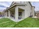 Spacious backyard with artificial turf and a covered patio area at 8137 Crushed Velvet Pl, Las Vegas, NV 89166