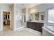 Bright bathroom with double vanity, glass shower, soaking tub and walk-in closet at 8137 Crushed Velvet Pl, Las Vegas, NV 89166