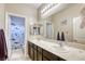 Bathroom featuring a double sink vanity with a shark themed shower curtain and bright lighting at 8137 Crushed Velvet Pl, Las Vegas, NV 89166