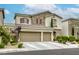 Two-story home with a three-car garage, stone accents, and well-maintained landscaping at 8137 Crushed Velvet Pl, Las Vegas, NV 89166