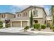 Exterior view of a two-story home with stone accents, manicured shrubs and a three-car garage at 8137 Crushed Velvet Pl, Las Vegas, NV 89166