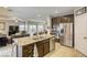 Island kitchen with stainless steel appliances, granite counters, and an open floor plan at 8137 Crushed Velvet Pl, Las Vegas, NV 89166
