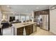 Island kitchen with stainless steel appliances, granite counters, and an open floor plan at 8137 Crushed Velvet Pl, Las Vegas, NV 89166