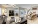 Bright living space with neutral décor, tile floors, and a seamless transition to the outdoor area at 8137 Crushed Velvet Pl, Las Vegas, NV 89166