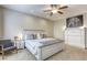 Main bedroom featuring a white fireplace, neutral walls, carpet, and a ceiling fan at 8137 Crushed Velvet Pl, Las Vegas, NV 89166