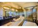 Elegant bathroom featuring dual sinks, granite countertops, tiled floors, large soaking tub, and a glass enclosed shower at 8310 W Camero Ave, Las Vegas, NV 89113