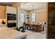 Bright dining room with modern chandelier, large windows, and views into kitchen at 8310 W Camero Ave, Las Vegas, NV 89113