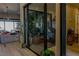 Relaxing indoor room with glass walls, plants, and massage chair, visible from the spacious living room at 8310 W Camero Ave, Las Vegas, NV 89113