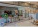 Open living room with modern decor, decorative stone wall, and access to kitchen at 8310 W Camero Ave, Las Vegas, NV 89113