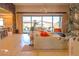Comfortable living room with large windows, plush seating, and seamless access to the outdoors at 8310 W Camero Ave, Las Vegas, NV 89113