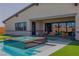 Backyard pool and spa area showcasing modern design, artificial turf, and patio with outdoor furniture at 8310 W Camero Ave, Las Vegas, NV 89113