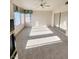 Light-filled bedroom with carpet, a ceiling fan, and a large window at 8788 Elise Ct, Henderson, NV 89074