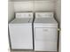Functional laundry room featuring a white washer and dryer set at 8788 Elise Ct, Henderson, NV 89074