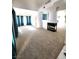 Open living room with plush carpet, fireplace, and plenty of natural light at 8788 Elise Ct, Henderson, NV 89074