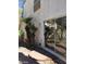 Backyard view of desert landscape, palm trees, and a sliding glass door at 8829 Cornwall Glen Ave, Las Vegas, NV 89129