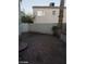 Backyard view with desert landscaping, a patio, a privacy wall and a palm tree at 8829 Cornwall Glen Ave, Las Vegas, NV 89129