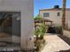 Backyard view with trees, privacy wall and a small gazebo with a hot tub at 8829 Cornwall Glen Ave, Las Vegas, NV 89129