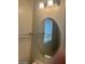 Bathroom featuring a decorative light fixture and a large round mirror hanging on the wall at 8829 Cornwall Glen Ave, Las Vegas, NV 89129