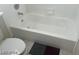 Standard white tub and toilet in a tidy bathroom at 8829 Cornwall Glen Ave, Las Vegas, NV 89129