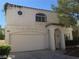 Charming two-story home featuring a red tile roof, arched window, and attached two car garage at 8829 Cornwall Glen Ave, Las Vegas, NV 89129