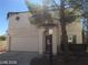 Charming two-story home featuring a red tile roof, arched window, and attached two car garage at 8829 Cornwall Glen Ave, Las Vegas, NV 89129