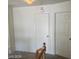 Neutral hallway with multiple white paneled doors and overhead lighting at 8829 Cornwall Glen Ave, Las Vegas, NV 89129