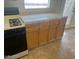 Kitchen featuring light wood cabinets, tiled countertops and black appliances at 8829 Cornwall Glen Ave, Las Vegas, NV 89129