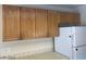 Kitchen shot showcasing wooden cabinets and a white refrigerator at 8829 Cornwall Glen Ave, Las Vegas, NV 89129