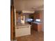 A cozy kitchen with wooden cabinets, and tiled countertops with a sink and breakfast bar at 8829 Cornwall Glen Ave, Las Vegas, NV 89129