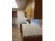 Kitchen boasting tile countertops, a gas range, and laundry machines in view at 8829 Cornwall Glen Ave, Las Vegas, NV 89129